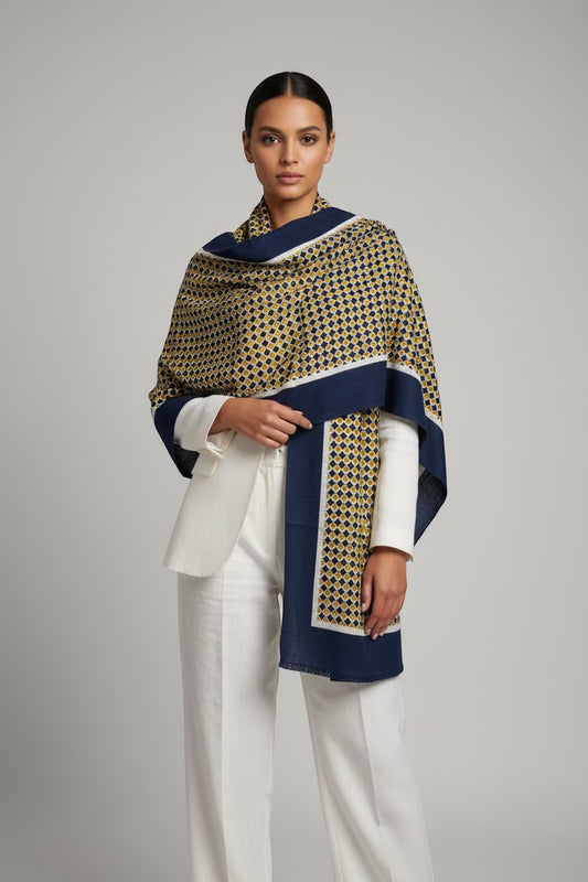 Eclectic navy and gold geometric print cashmere wool blend wrap worn over a white blazer