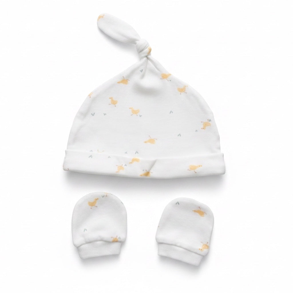 Eclectic newborn knotted hat and matching mittens set in white cotton with a soft yellow duck print.