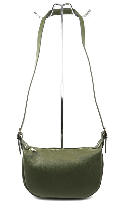 Eclectic olive green grained leather half moon sling bag with an adjustable strap and gold-tone hardware on a stand.