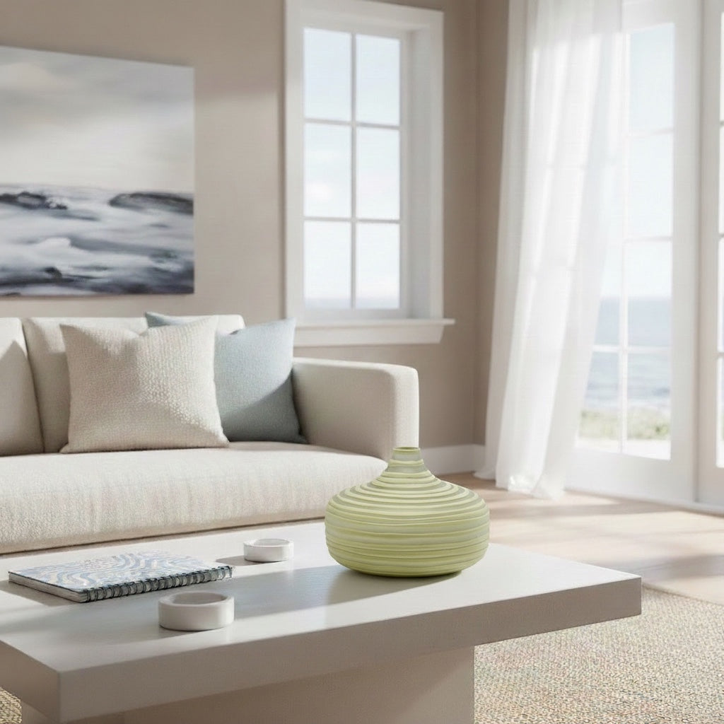 Eclectic wide olive ribbed glass vase on a white coffee table in a bright, contemporary living room setting.