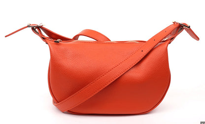 Eclectic orange grained leather half moon sling bag with an adjustable strap and gold-tone hardware.