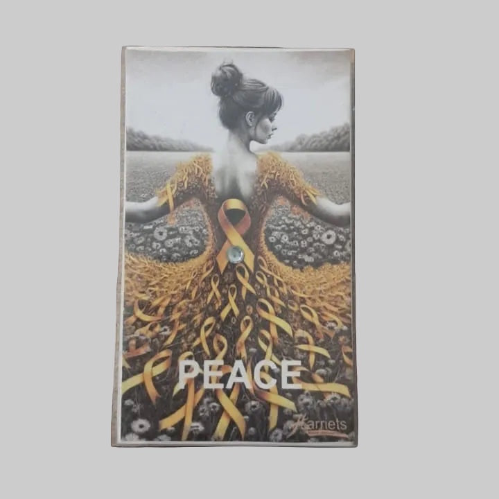 Eclectic decorative matchbox featuring a woman in a yellow ribbon dress with the word PEACE in a field