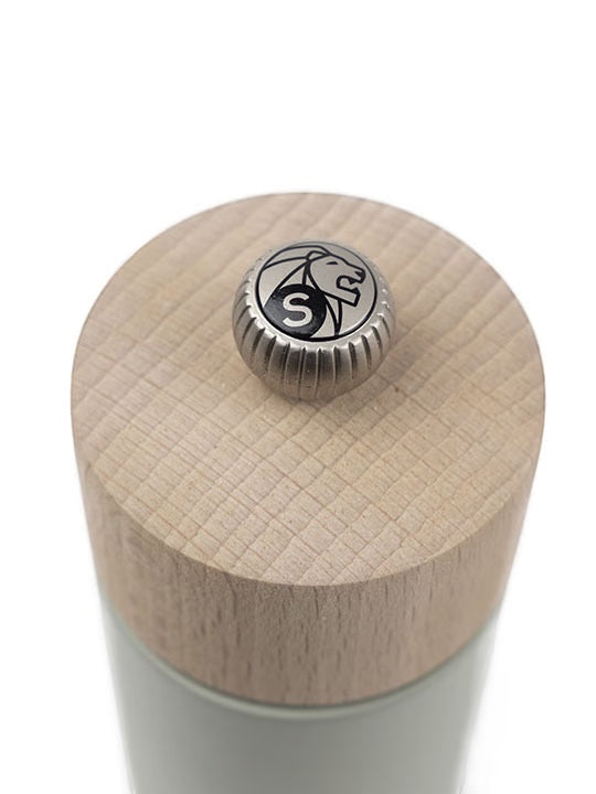 Eclectic Peugeot Boreal salt mill top view showing the natural beechwood cap and adjustable metal grinding button