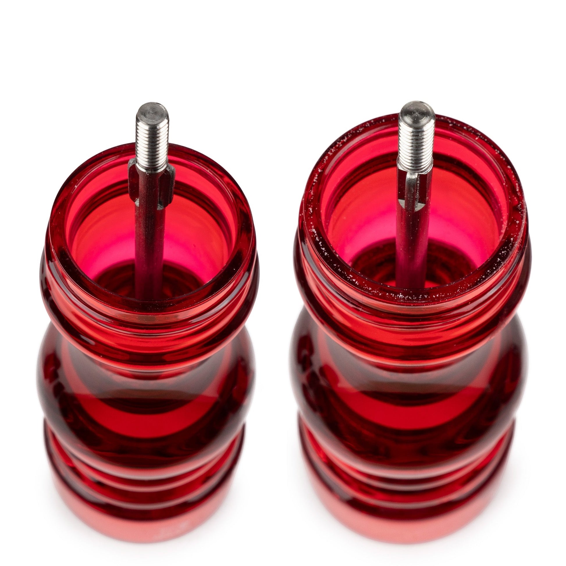 Eclectic Peugeot Podium red acrylic salt and pepper mill set top view showing internal steel grinding mechanisms