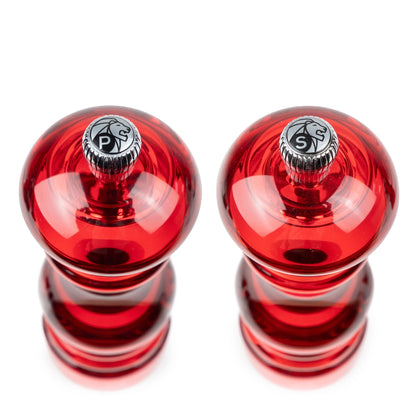 Eclectic Peugeot Podium red acrylic salt and pepper mill set, 18 cm tall, viewed from above.