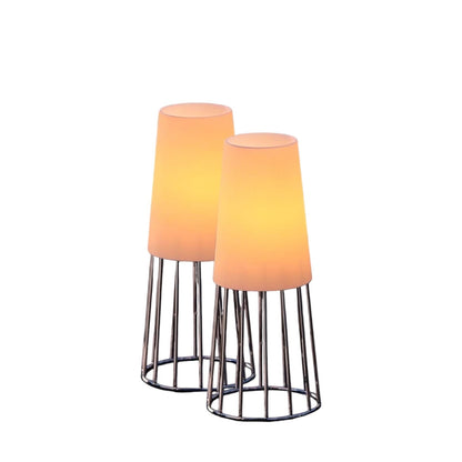 Eclectic Philippi Lighthouse tea light holders with polished silver wire bases and frosted glass shades glowing warm.
