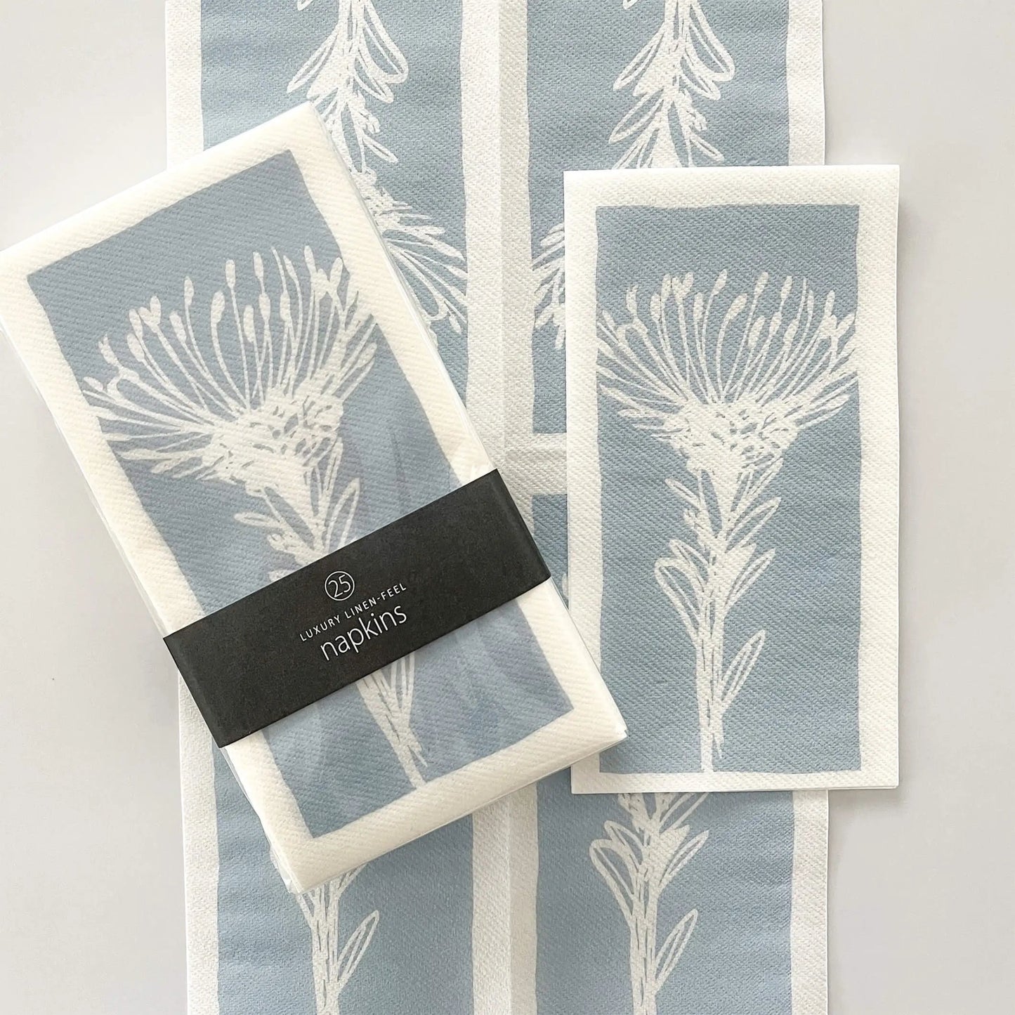 Eclectic Pincushion Blue disposable airlaid napkins with a botanical protea print in a pack of 25