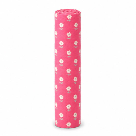Eclectic pink cotton flannel baby blanket featuring a delicate white blossom floral pattern, rolled for storage.