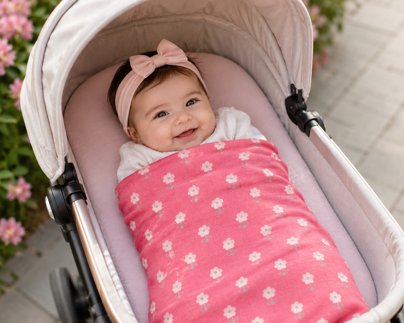 Eclectic baby girl in a stroller wrapped in a soft pink cotton flannel blanket with a white floral polka dot pattern.