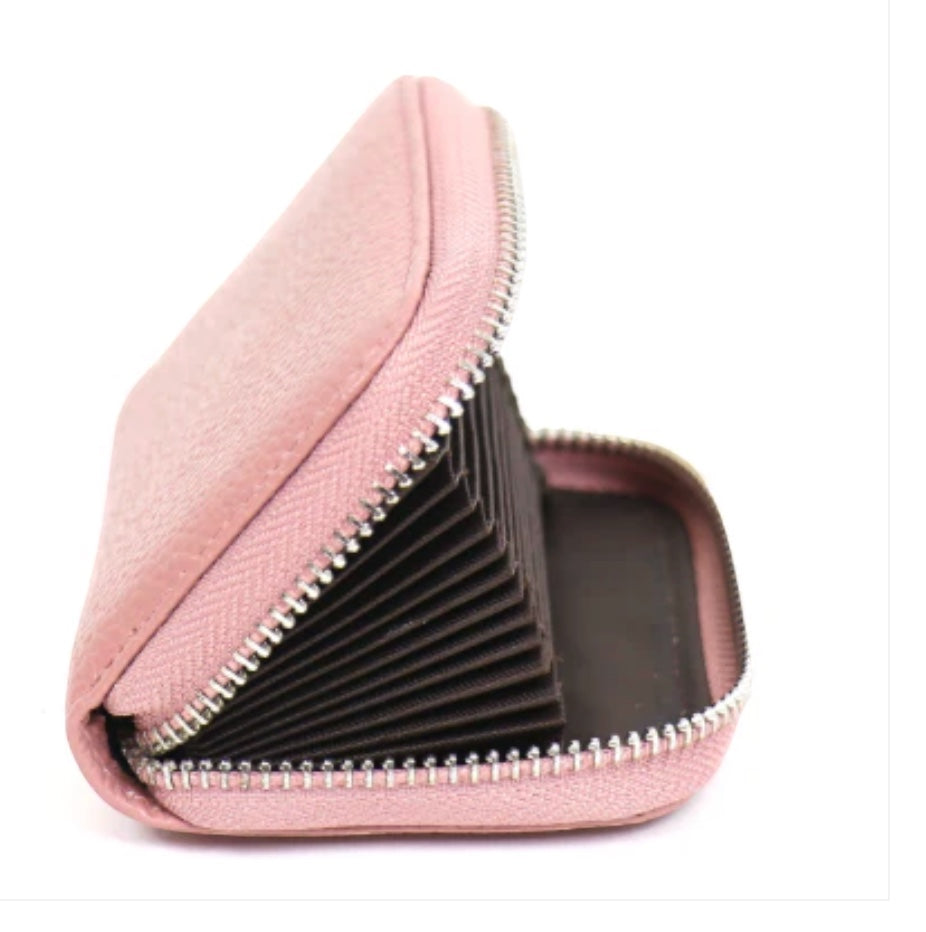 Eclectic pink pebbled leather zip-around card holder with an open accordion-style interior and silver hardware.