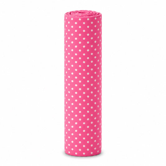 Eclectic pink cotton flannel baby blanket rolled up featuring a white polka dot pattern for soft nursery comfort.