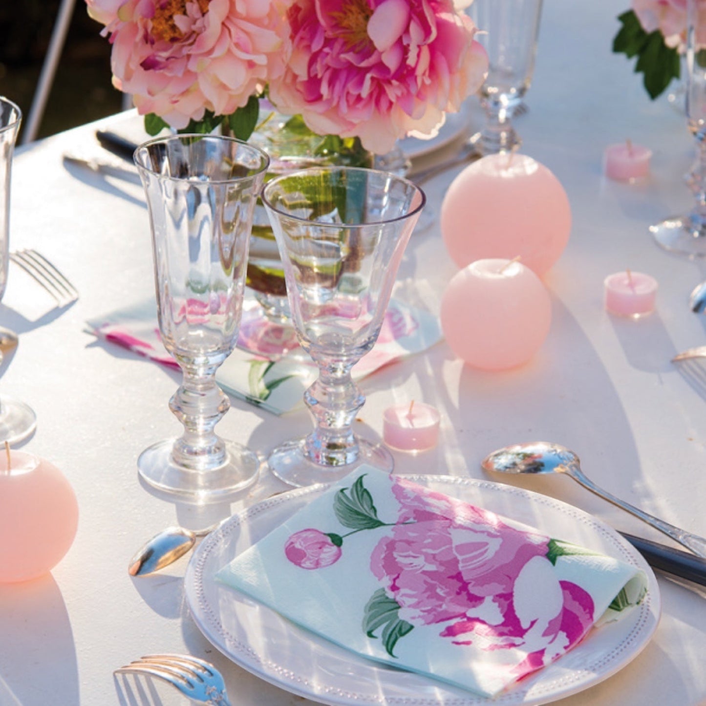 Eclectic Pivoine dinner napkin with pink peony floral print on a white plate at a romantic table setting