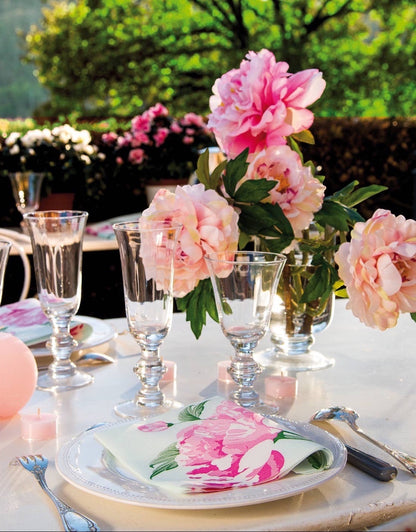 Eclectic Pivoine dinner napkin with pink peony motif on a white plate, styled for an elegant outdoor table setting.
