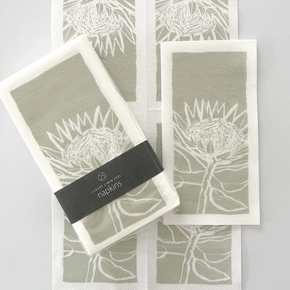 Eclectic Protea Green disposable airlaid napkins with a linen-like texture and botanical protea flower print.