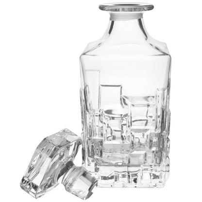 Eclectic RCR Etna crystal whisky decanter with geometric cut patterns and matching glass stopper on white background