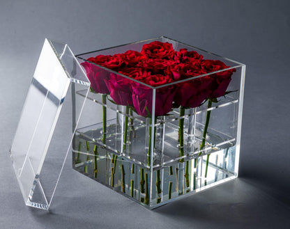 Eclectic rose box featuring deep red roses arranged in a clear acrylic square container with a removable lid.