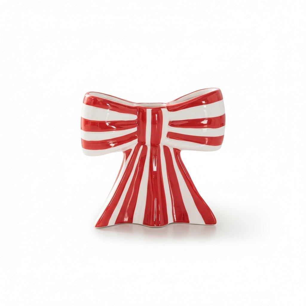 Eclectic red and white striped ceramic bow-shaped taper candle holder with a smooth glazed finish.
