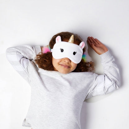 Eclectic Relaxeazzz Astrid the Unicorn eye mask worn by a young girl with curly hair against a white background