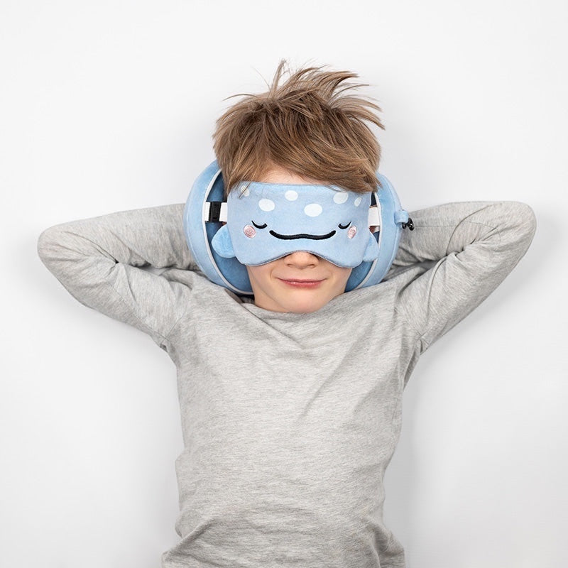 Eclectic Relaxeazzz Aoi the Whale Shark travel pillow and matching eye mask worn by a young boy on a white background.