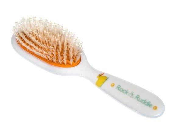 Eclectic Rock & Ruddle baby hairbrush with natural boar bristles and a cute duckling design on a white handle