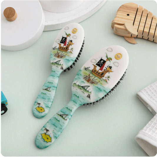 Eclectic Rock & Ruddle High Seas baby hairbrushes with nautical pirate ship illustrations and natural boar bristles.
