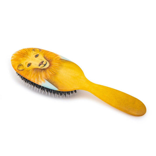Eclectic Rock & Ruddle baby hairbrush featuring a golden lion illustration with natural boar bristles and nylon tips