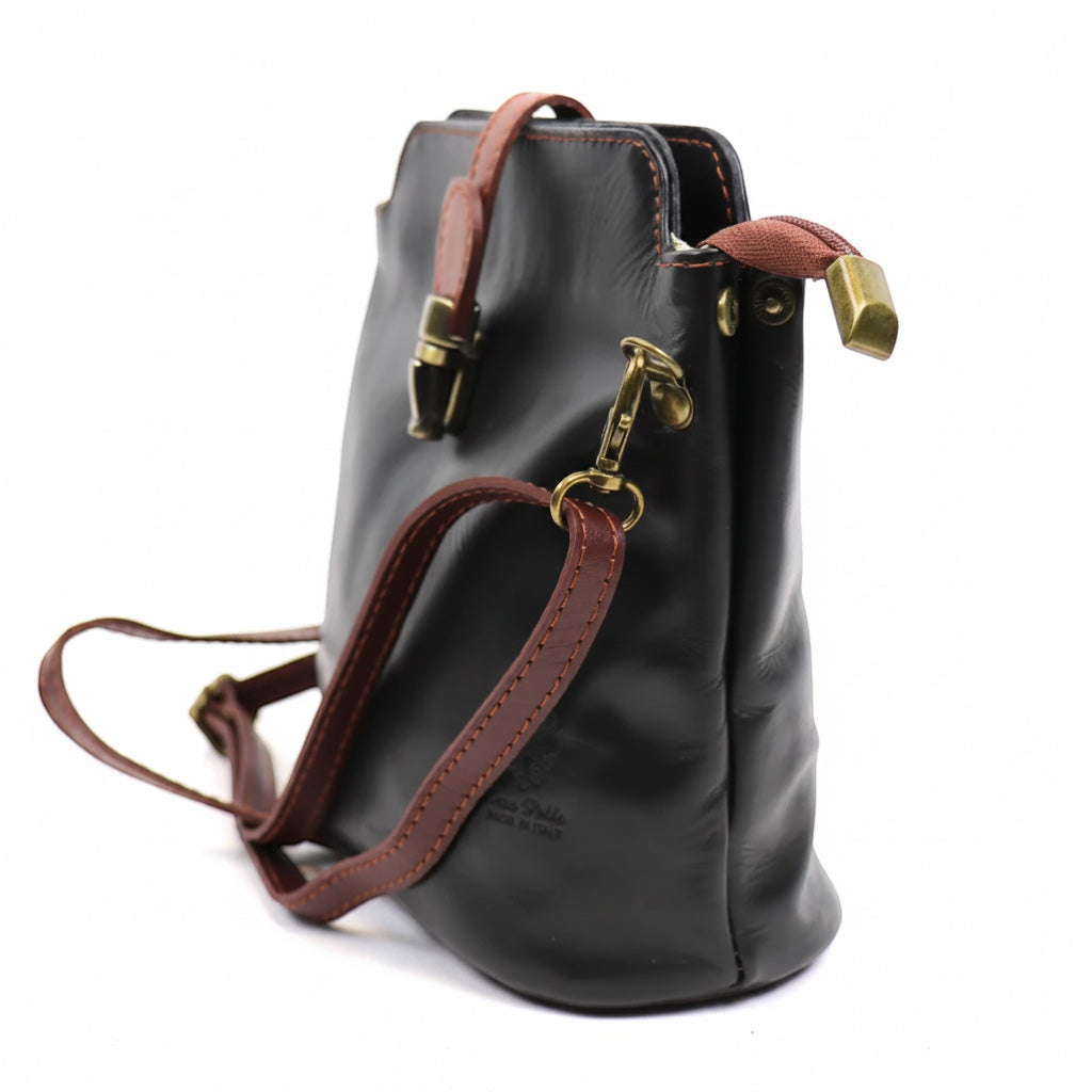 Eclectic Roma leather crossbody bag in black with tan trim, gold hardware, and adjustable strap, side view.