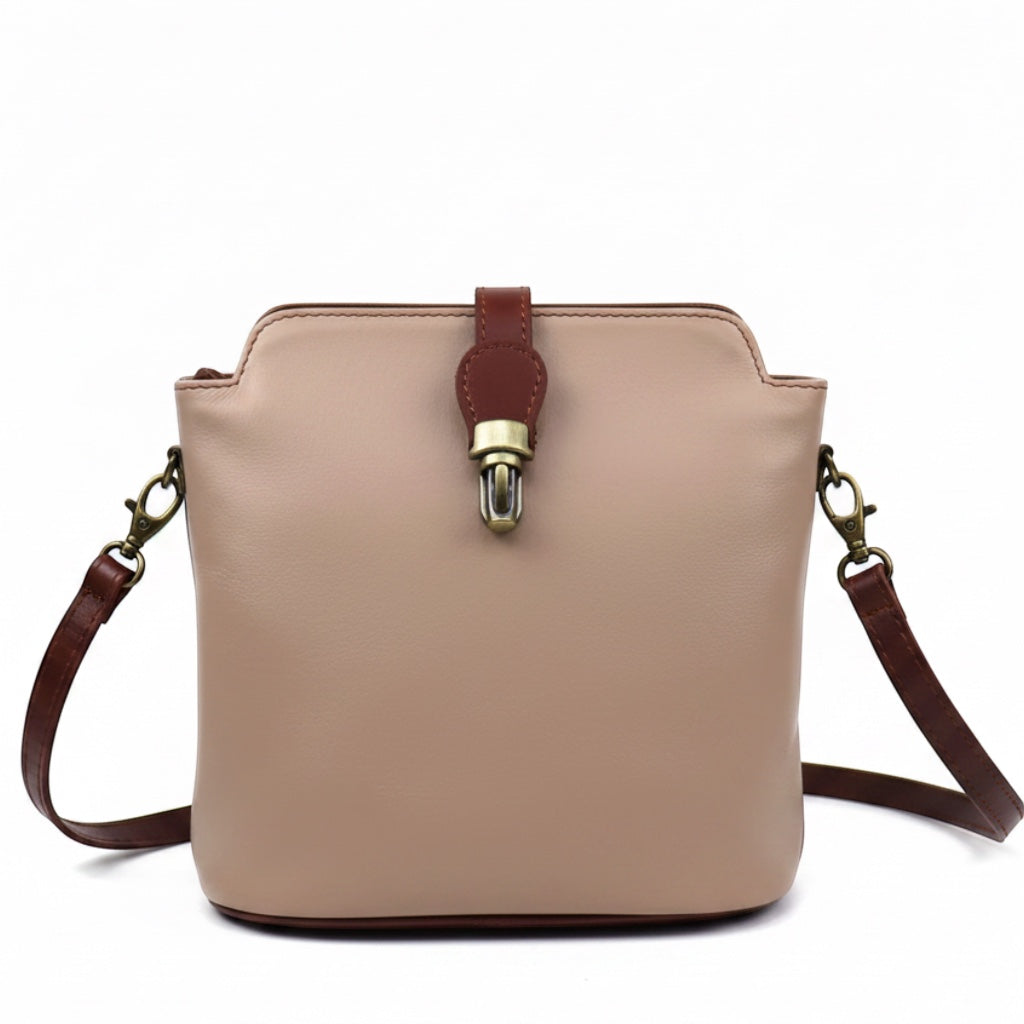 Eclectic Roma leather crossbody bag in beige with tan trim, gold hardware, and a decorative buckle detail.