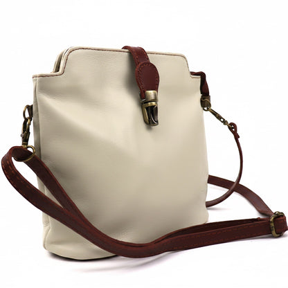Eclectic Roma leather crossbody bag in cream with tan trim, gold hardware, and adjustable strap on white background.