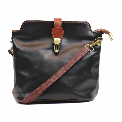 Eclectic Roma leather crossbody bag in black with tan trim, gold hardware, and a decorative buckle detail.