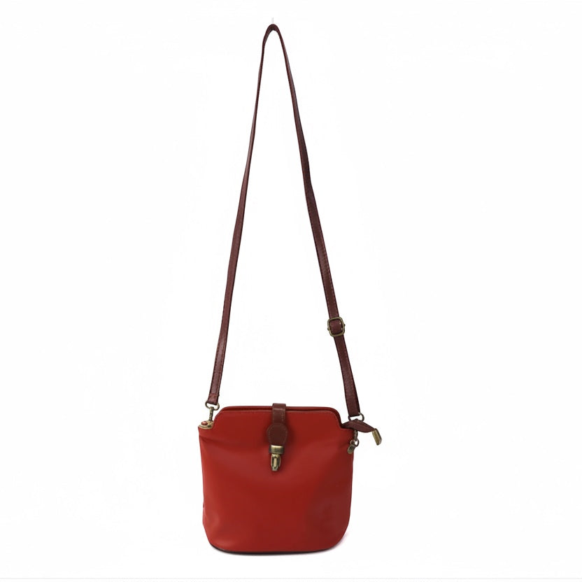 Eclectic Roma leather crossbody bag in red with tan trim, gold-tone hardware, and an adjustable shoulder strap.