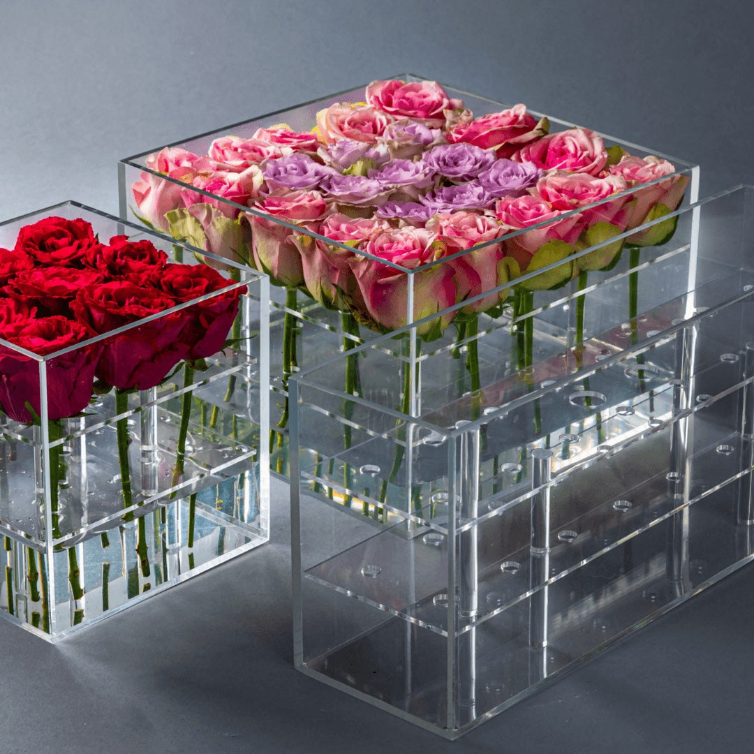 Eclectic Rose Box set featuring clear acrylic containers filled with vibrant red, pink, and purple fresh roses.
