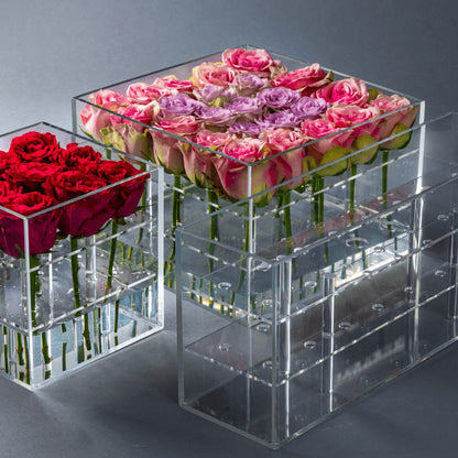 Eclectic Rose Box set featuring clear acrylic containers filled with vibrant red, pink, and purple fresh roses.