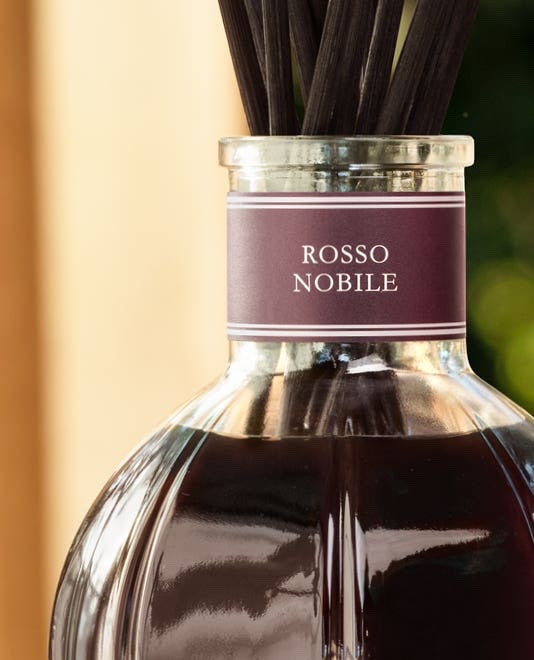 Eclectic Dr Vranjes Rosso Nobile reed diffuser in a classic glass bottle with dark fragrance and black reeds.
