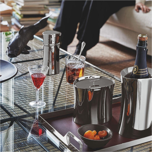 Eclectic Sambonet Bamboo insulated ice bucket in mirror-polished stainless steel on a tray with bar accessories.