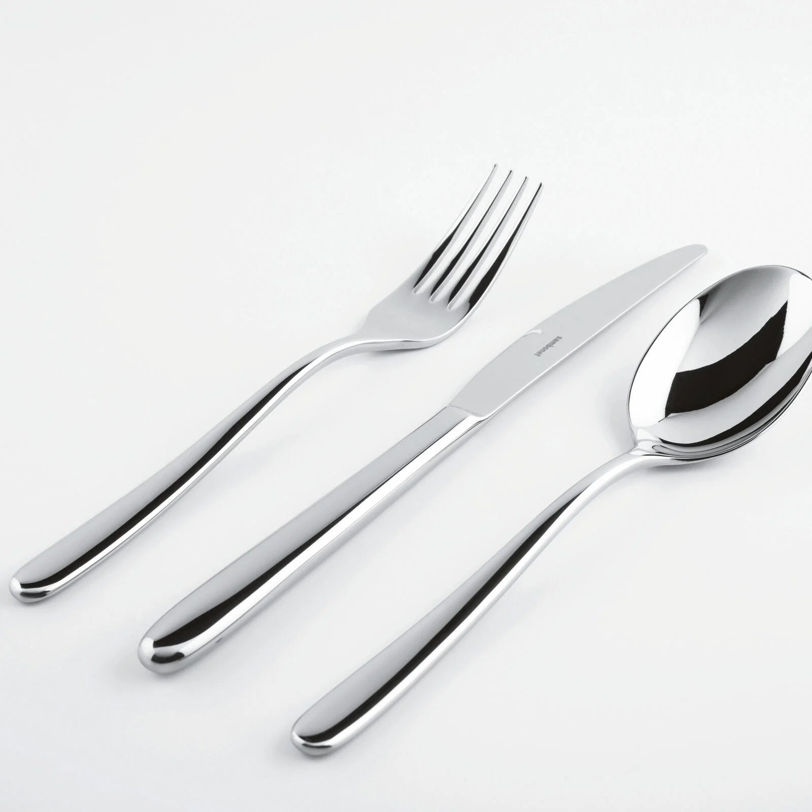 Eclectic Sambonet Hannah stainless steel cutlery set including a fork, knife, and spoon with a mirror-polished finish.
