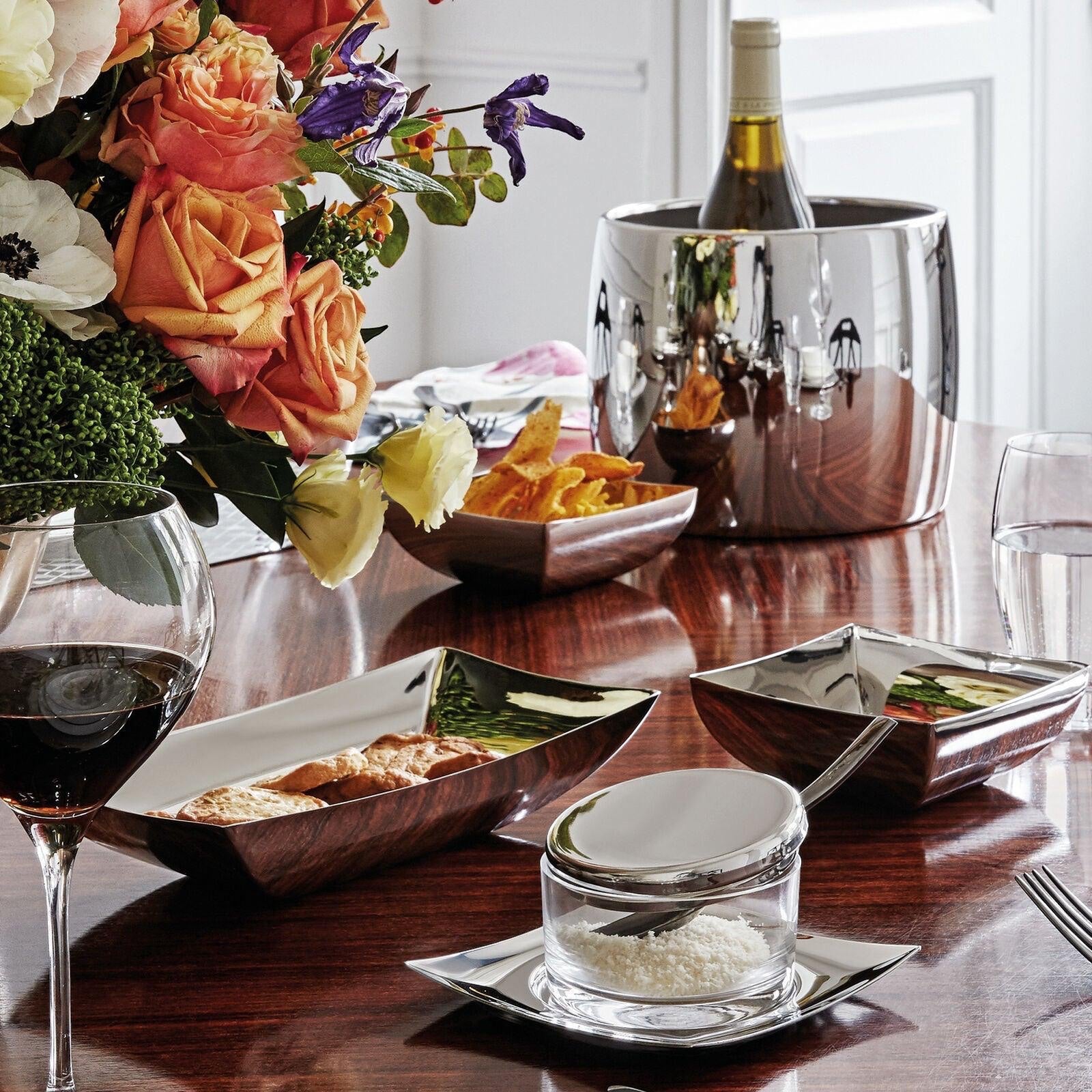 Eclectic Sambonet Linea Q stainless steel bread basket and square bowls with polished silver finish on a dining table