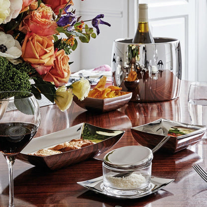Eclectic Sambonet Linea Q stainless steel bread basket and square bowls with polished silver finish on a dining table