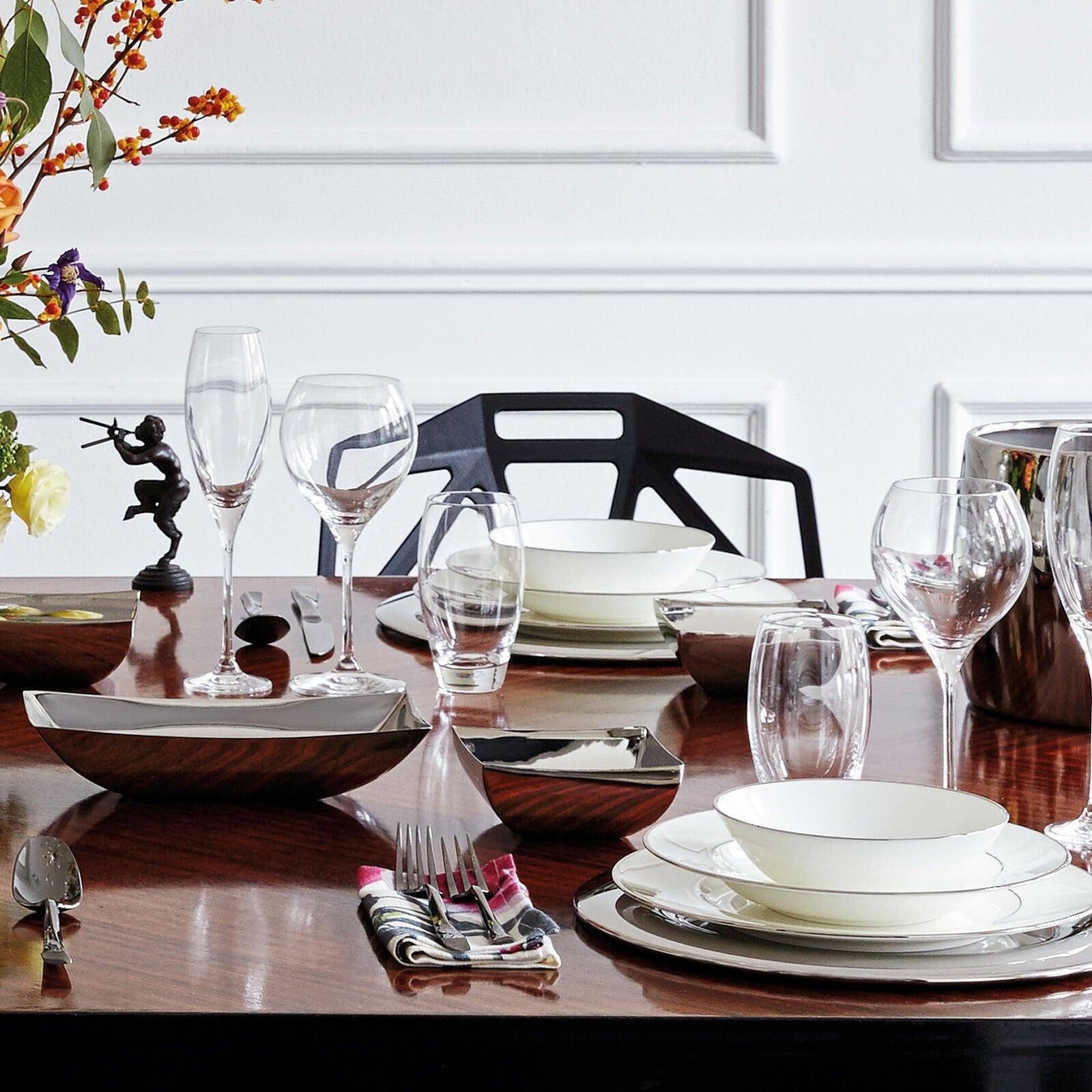 Eclectic Sambonet Linea Q stainless steel bread basket and square bowls set on a formal dining table