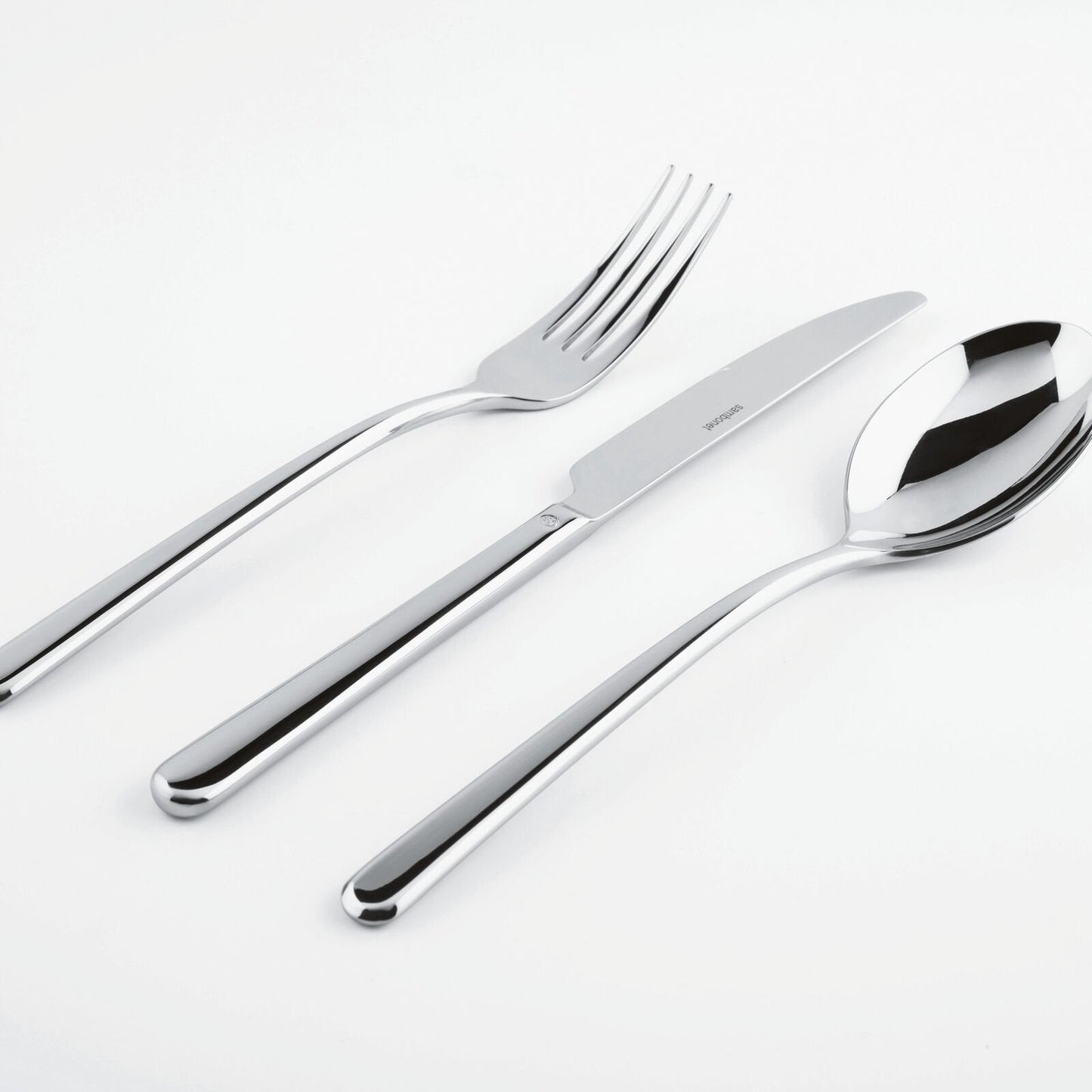 Eclectic Sambonet Linear cutlery set featuring a mirror-polished stainless steel fork, knife, and spoon.