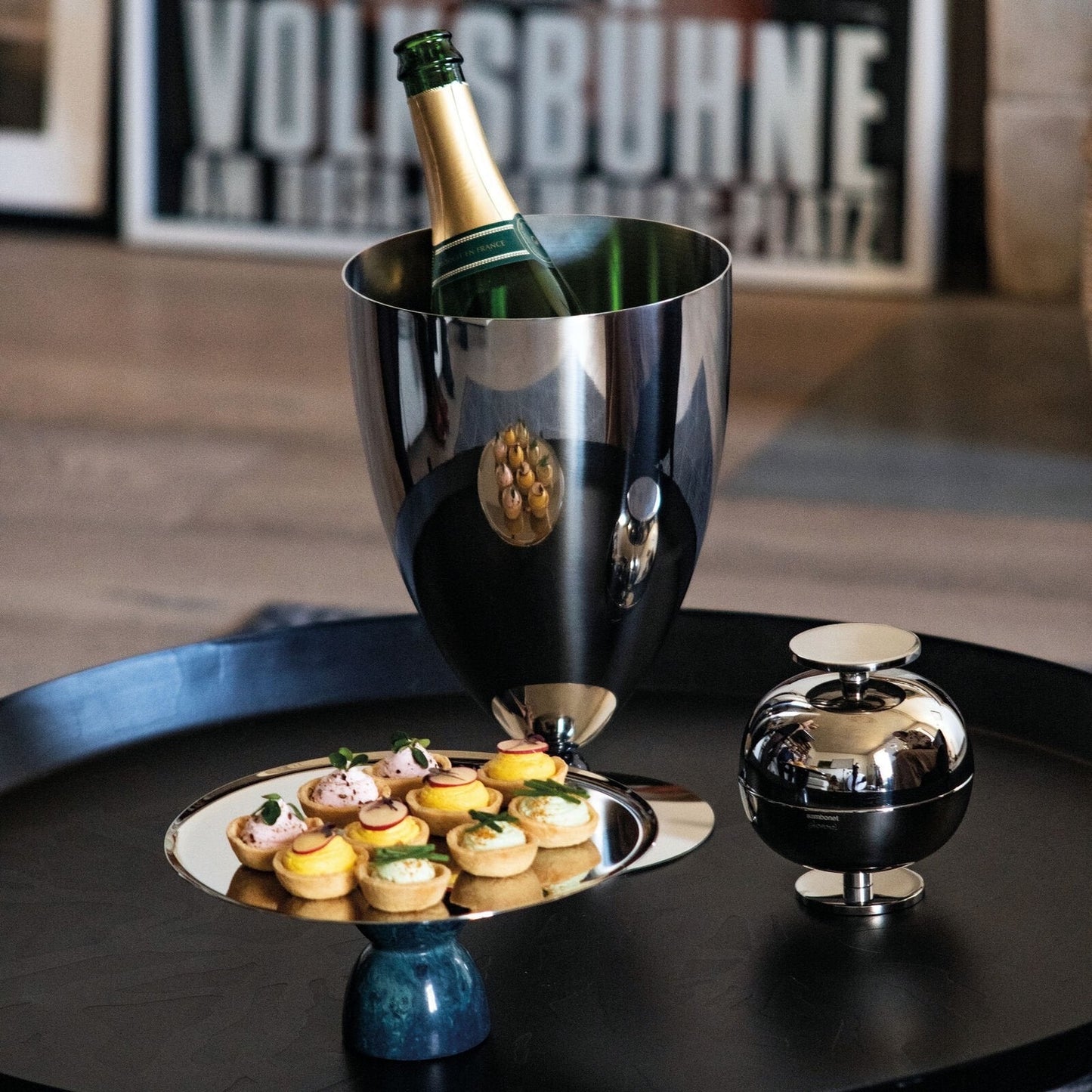 Eclectic Sambonet Penelope ice bucket in mirror-polished stainless steel with black marble-effect resin accents.