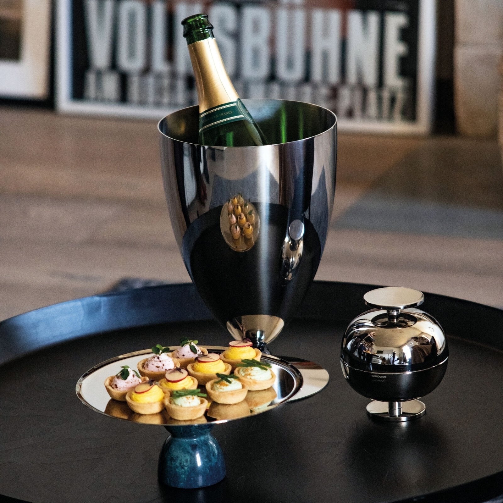 Eclectic Sambonet Penelope ice bucket in mirror-polished stainless steel with black marble-effect resin accents.