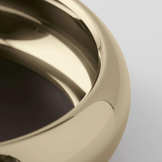 Eclectic Sambonet Sphera 32cm serving bowl in champagne PVD stainless steel with a smooth, reflective organic silhouette.