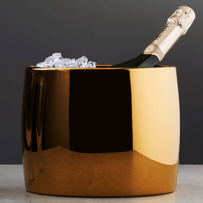 Eclectic Sambonet Sphera oval wine cooler in cognac PVD stainless steel with a champagne bottle and ice