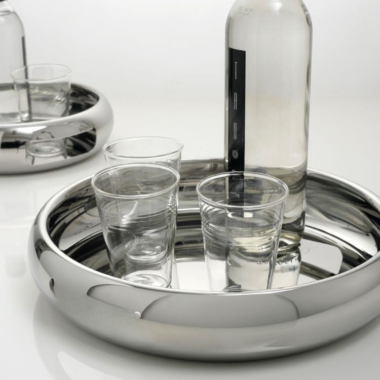 Eclectic Sambonet Sphera 32cm mirror-polished stainless steel serving bowl holding a glass bottle and drinking glasses.