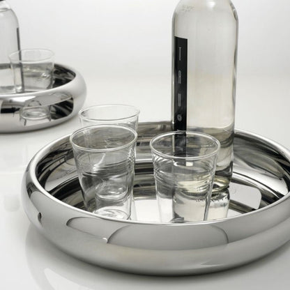 Eclectic Sambonet Sphera 32cm mirror-polished stainless steel serving bowl holding a glass bottle and drinking glasses.