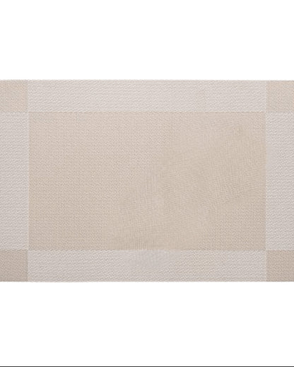 Eclectic sand coloured rectangular PVC placemat with a subtle woven texture and a clean border design.