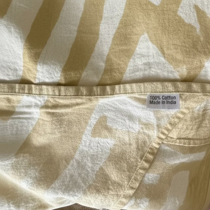 Eclectic sand and white abstract pattern 100% cotton tablecloth with hemmed edge and fabric origin label