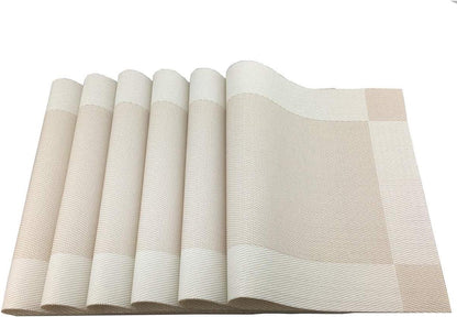 Eclectic set of four rectangular sand-coloured woven PVC placemats with a subtle textured finish.