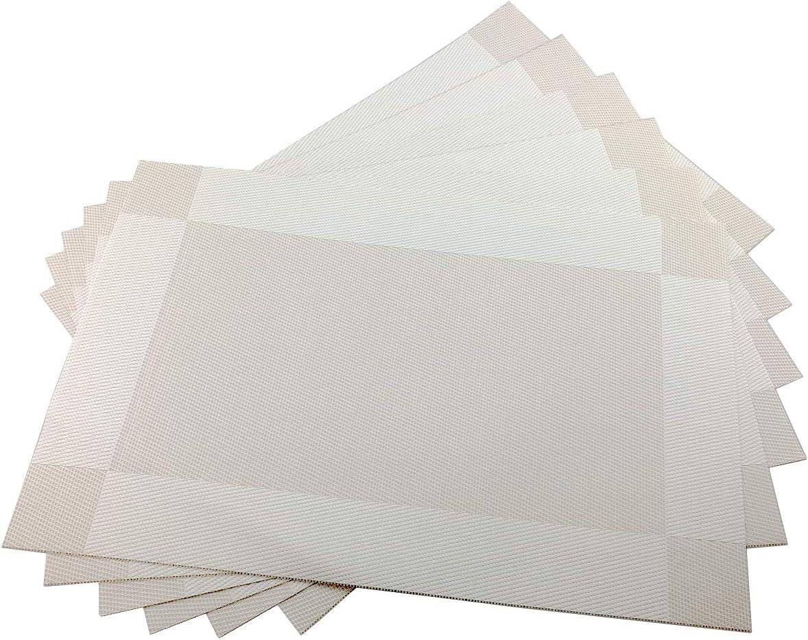 Eclectic set of four rectangular sand-coloured woven PVC placemats with a subtle textured border for dining tables.